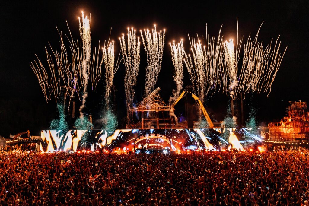 Mainstage do Tomorrowland 2025 em Boom, Bélgica, com show de fogos de artifício e milhares de fãs celebrando o festival de música eletrônica.